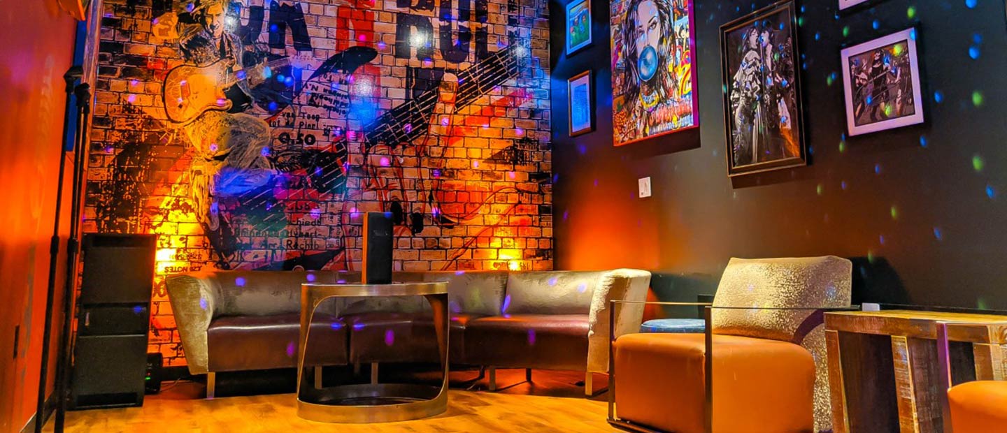 Karaoke Room with Couches and Disco Ball Reflections